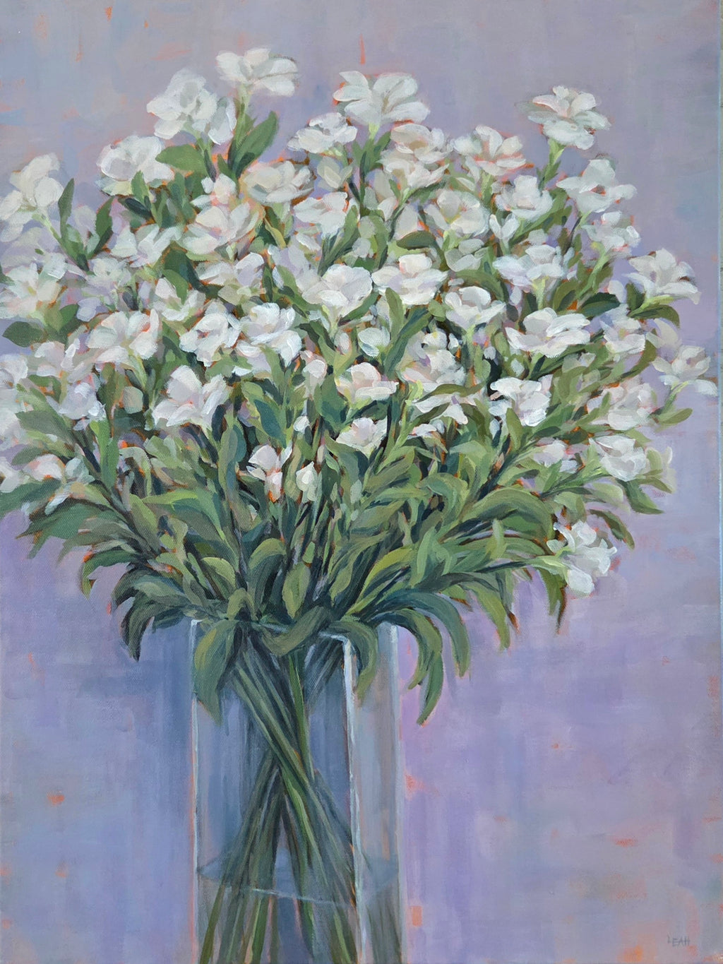 White flowers in glass vase with lavender background. 