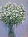 White flowers in glass vase with lavender background. 
